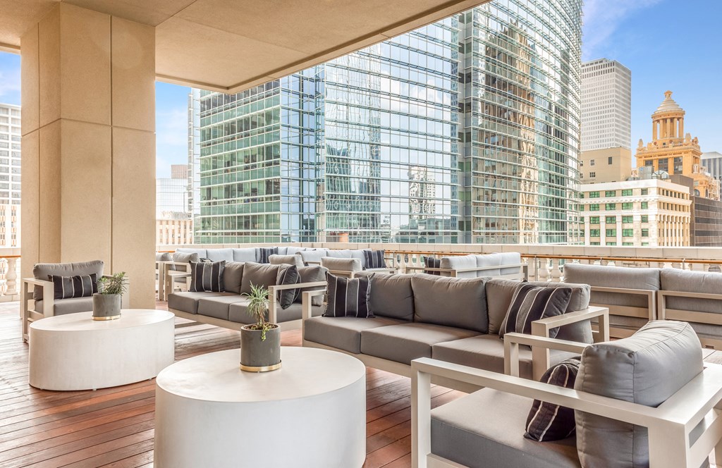 a rendering of a rooftop patio with couches and tables