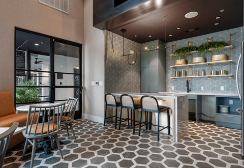 A modern kitchen with a dining table and chairs.