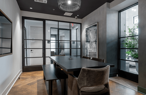 A modern dining room with a large table and chairs.