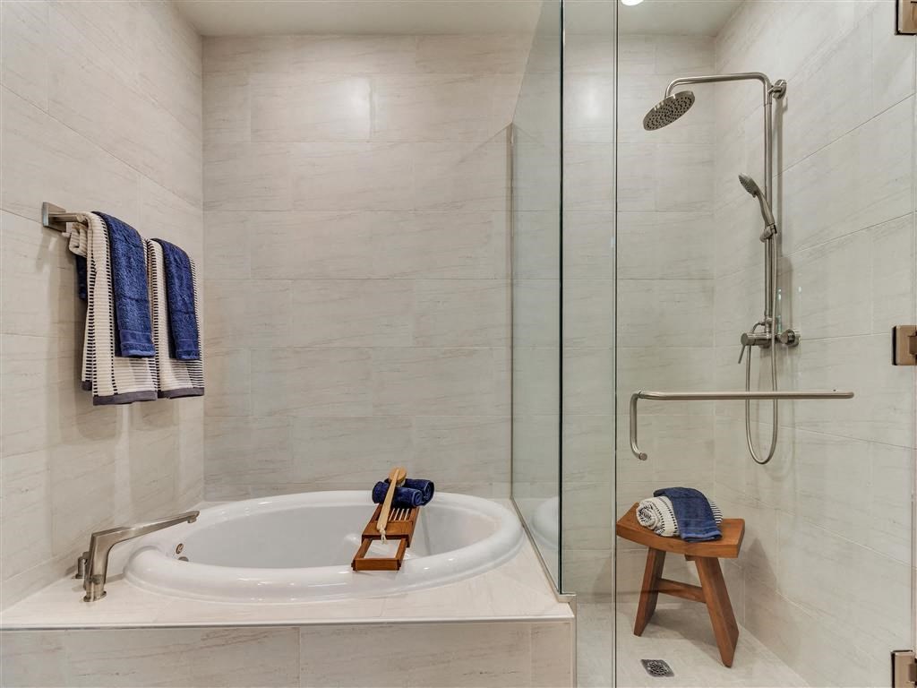 Large oval soaking tubs and separate shower.