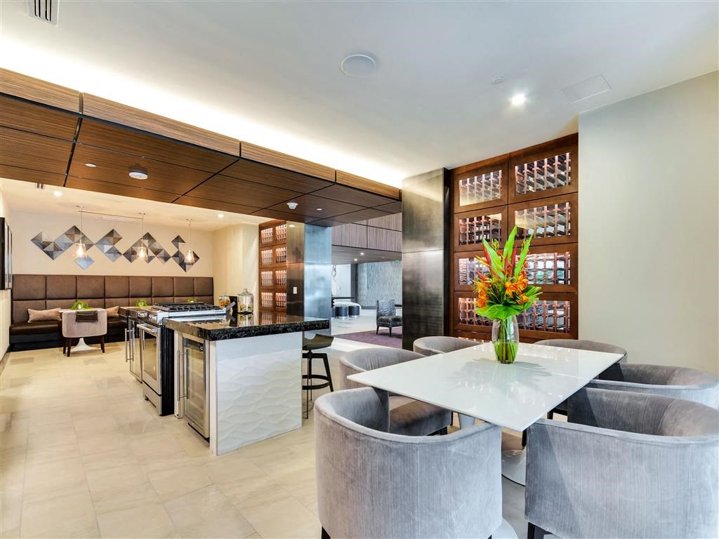 Community clubroom with catering kitchen and seating for dining.