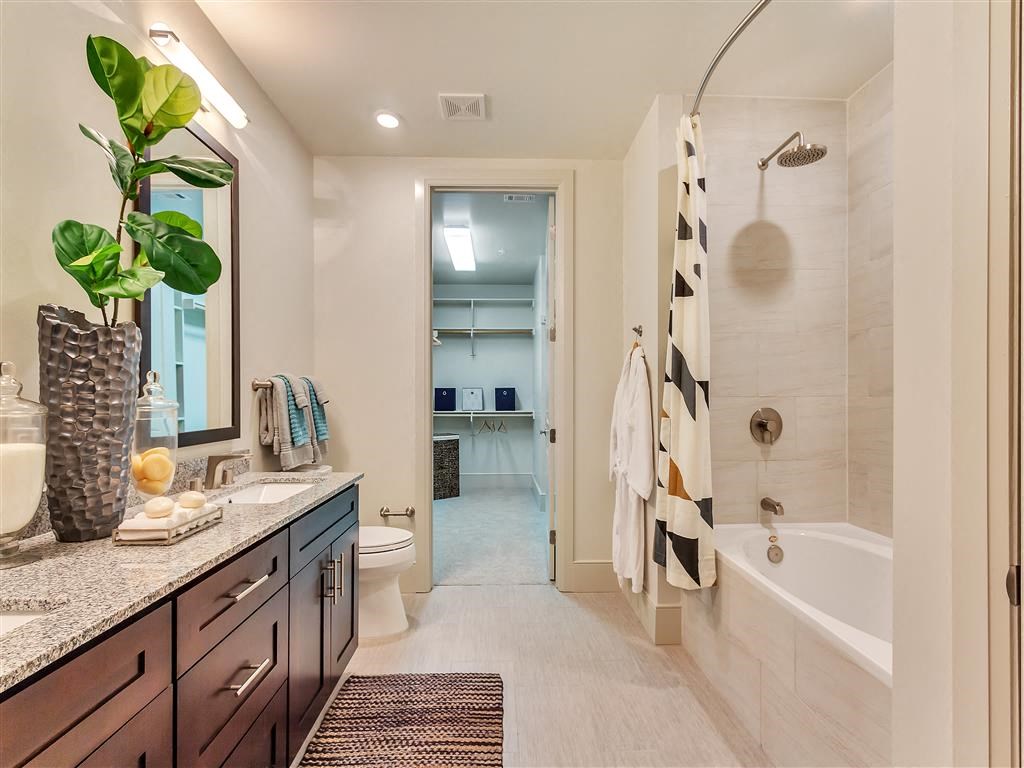 Spacious bathroom with oval soaking tub and double vanity.