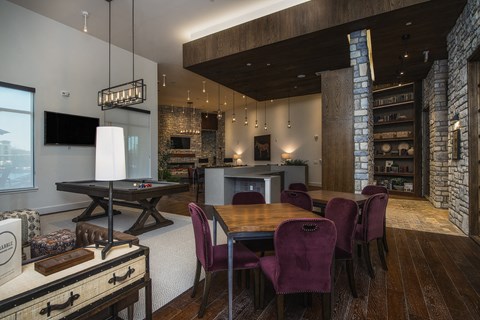 A modern kitchen with a dining table and chairs.