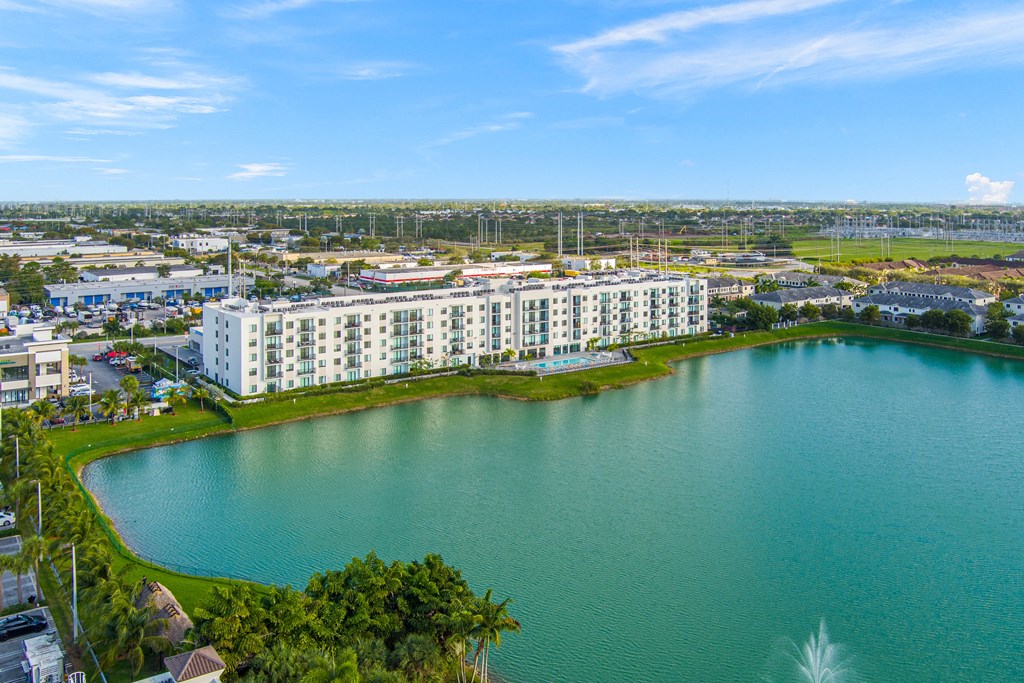 An aerial view of a large lake with apartments in the background