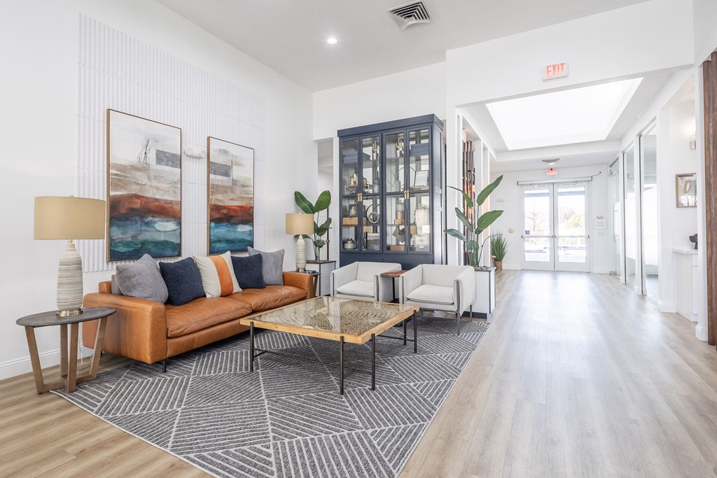 a living room with a leather couch and a coffee table
