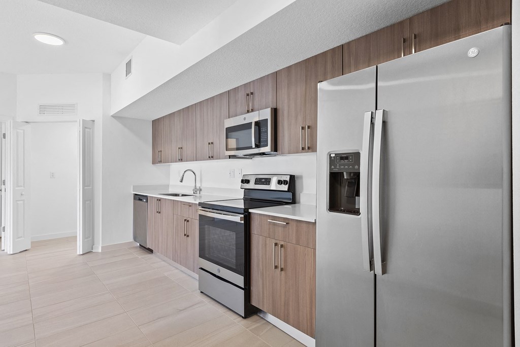 a kitchen with wooden cabinets and stainless steel appliances