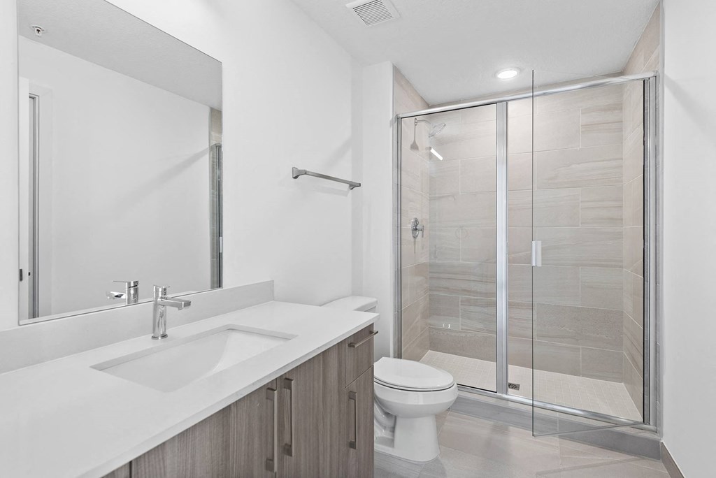 a bathroom with a toilet sink and shower