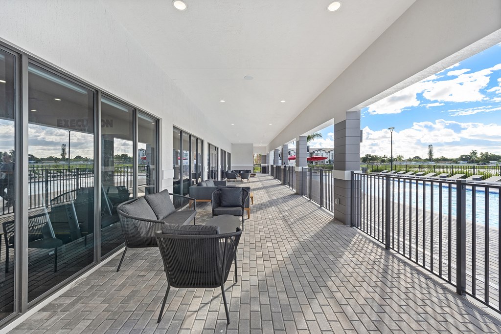 a spacious patio with chairs and tables overlooking a body of water
