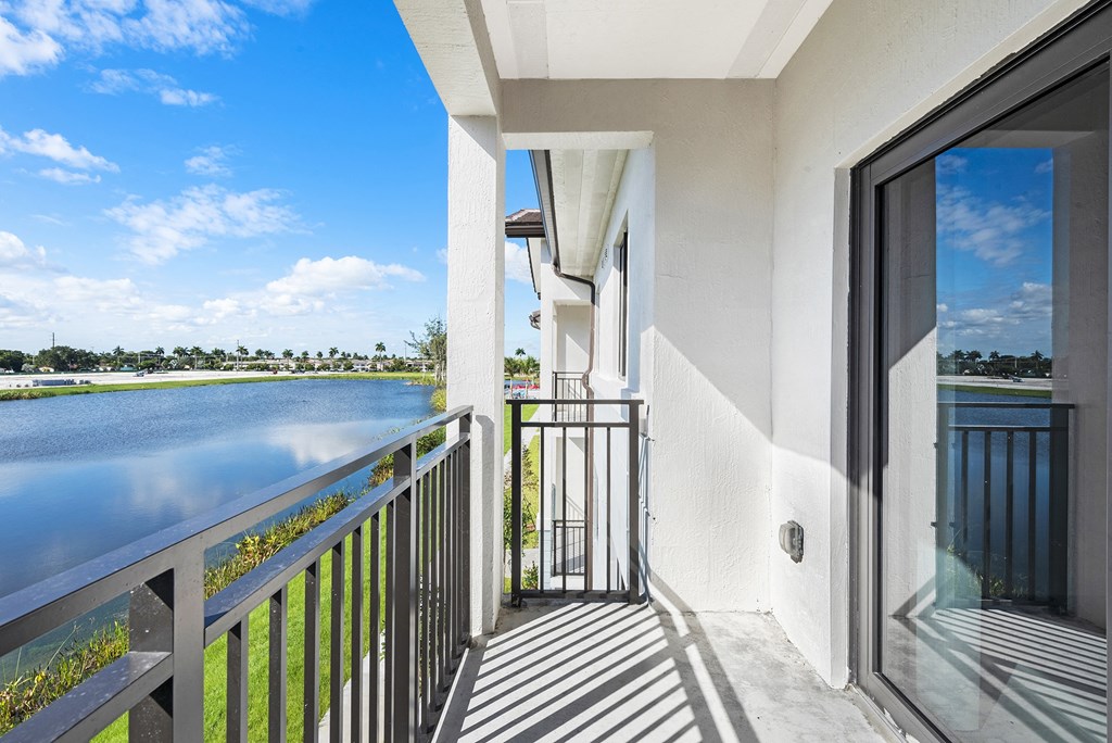 a balcony with a view of a body of water