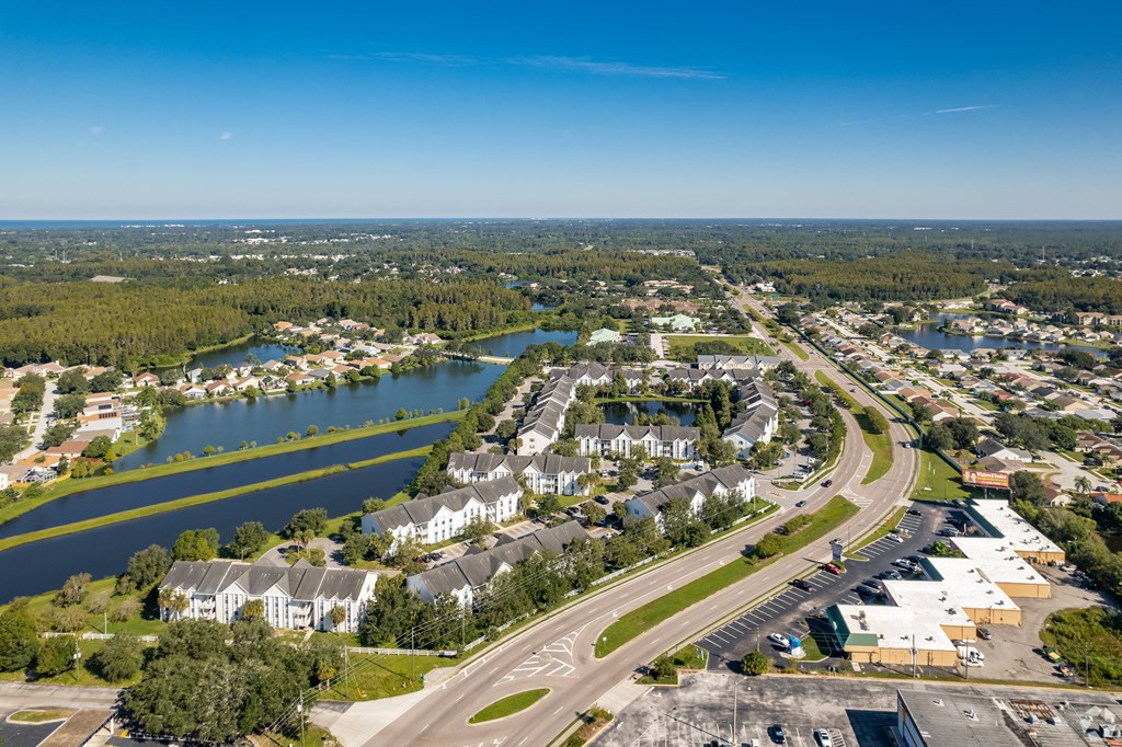 an aerial view of a city with a river and houses