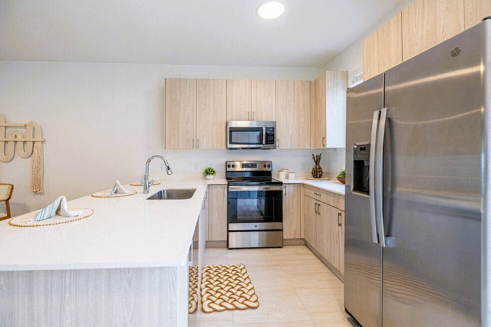 a kitchen with stainless steel appliances and a white counter top