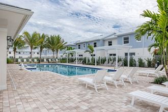 a view of a swimming pool with white umbrellas