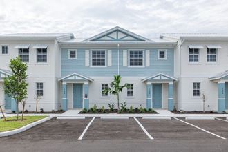 a blue and white building with a parking lot