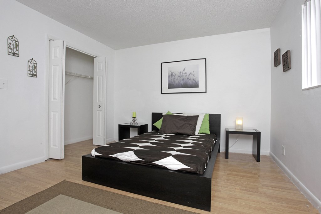 an overview of a bedroom with a bed and a closet