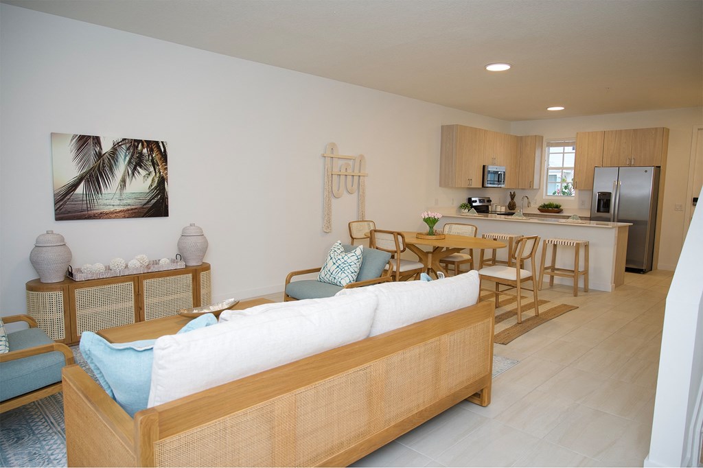 a living room with a couch and a table and a kitchen