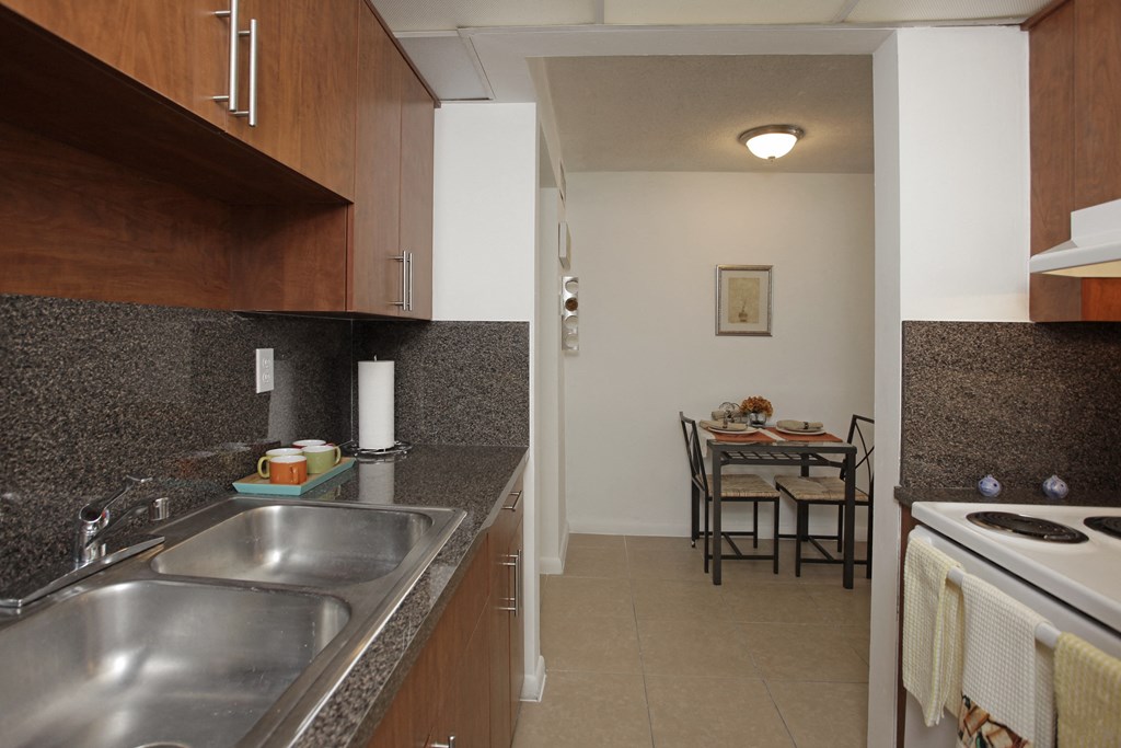 a view of a kitchen and a dining room with a table
