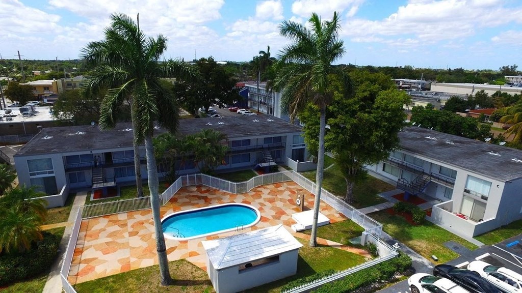 a property with a swimming pool and palm trees