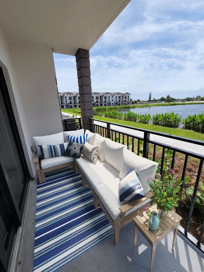 a balcony with a couch and pillows on it