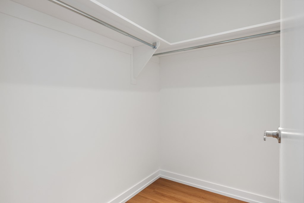an empty room with white walls and a sliding door