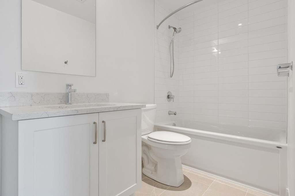 a bathroom with a toilet and a tub and a sink