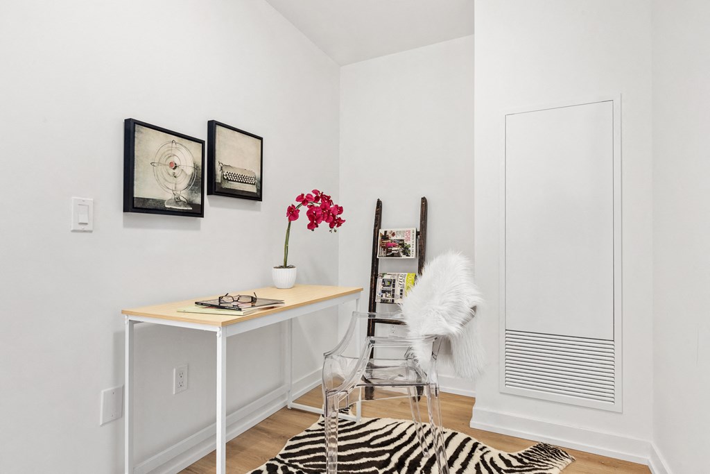 a white office with a desk and a zebra rug