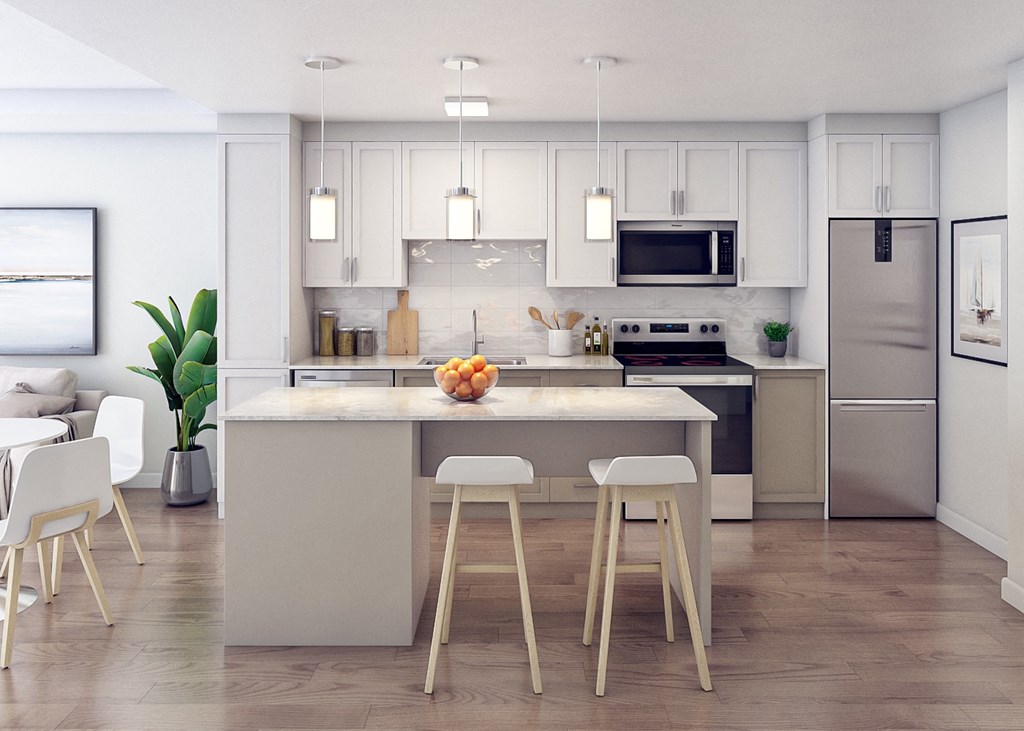 a kitchen with white cabinets and a large island with bar stools