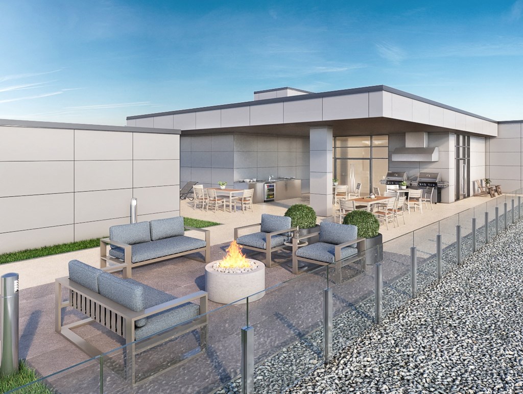 a rendering of a patio with chairs and a fire pit in front of a building