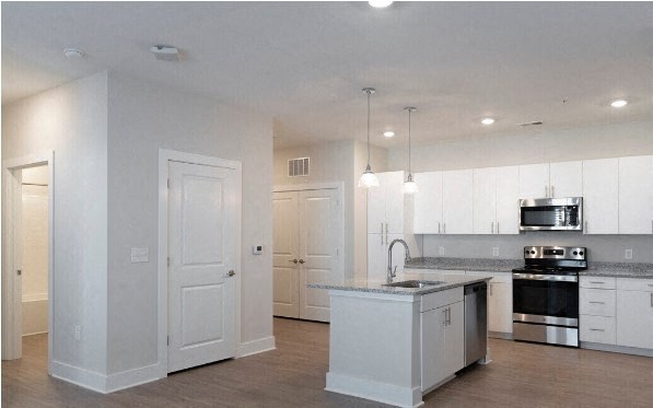 a large kitchen with white cabinets and a counter top