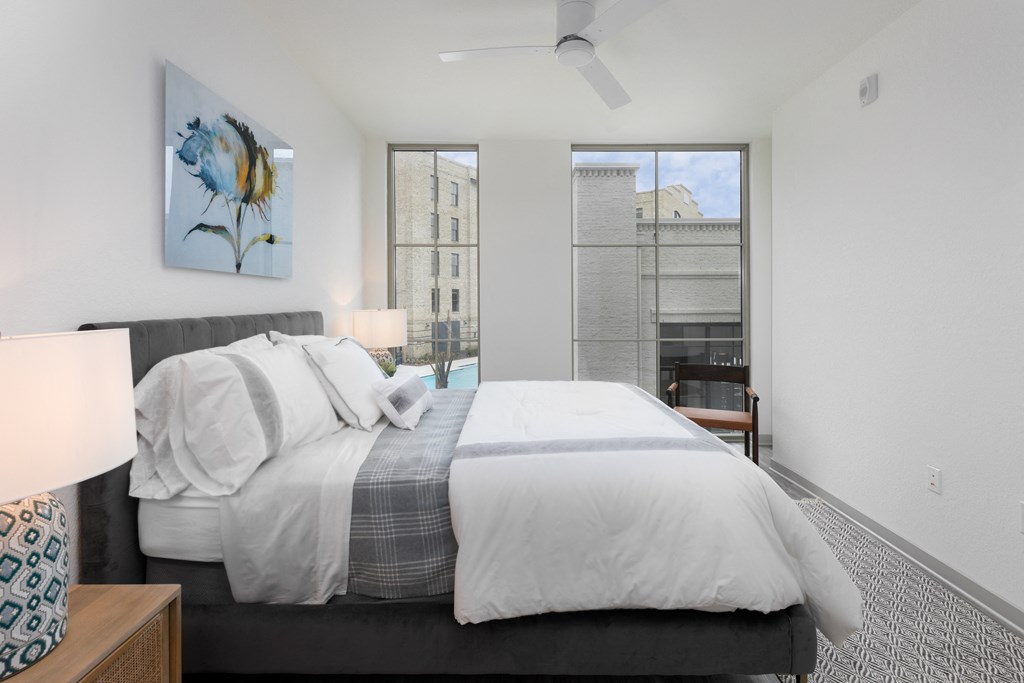 a bedroom with a large bed and a large window