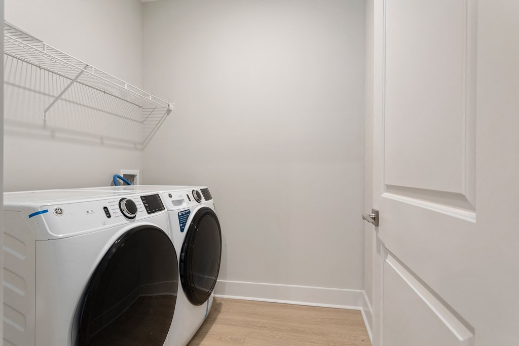 a washer and dryer in a laundry room with a white door