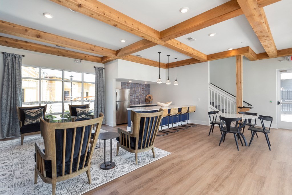 a living room with a dining room table and chairs and a kitchen