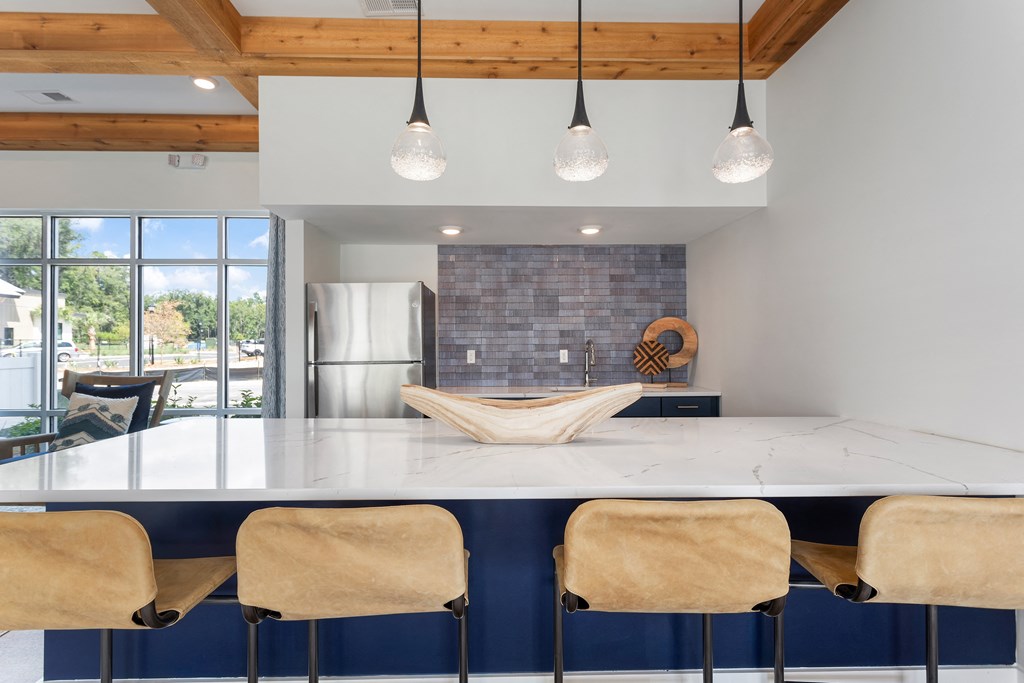 a kitchen with a large island with a wooden bowl on top of it