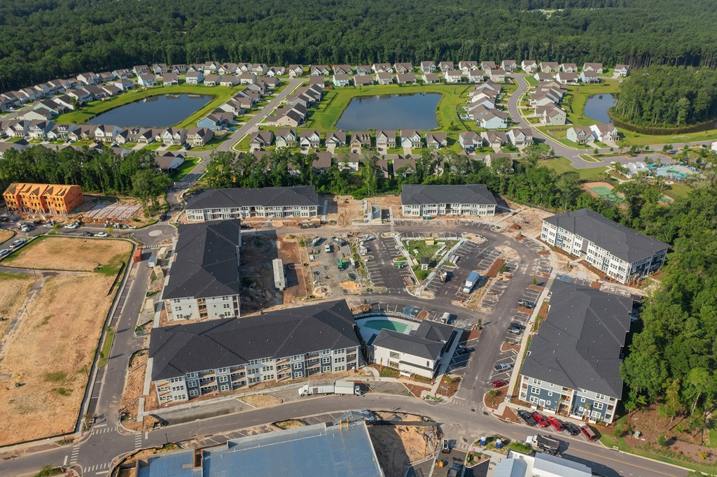 an aerial view of a city with buildings and a body of water