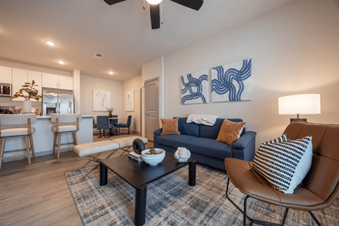 A living room with a blue couch and a coffee table.