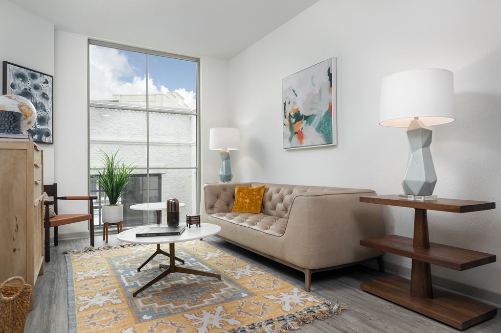 a living room with a couch and a table and a window