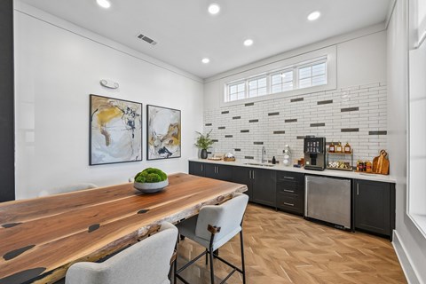 A modern kitchen with a wooden table and chairs.