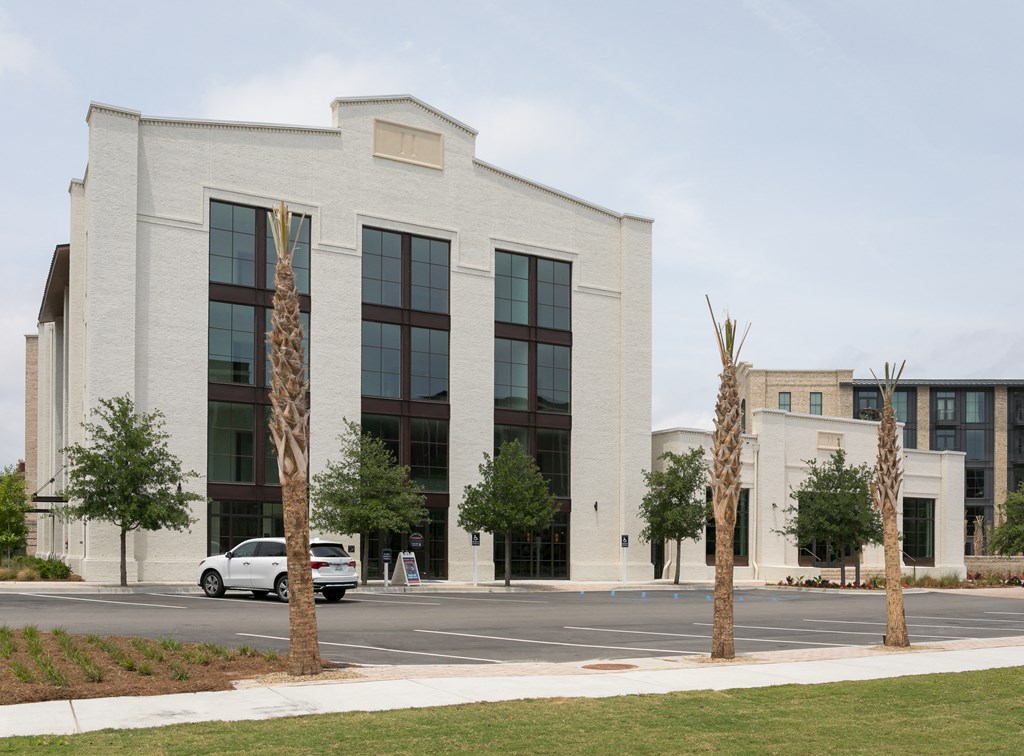 an office building with a car parked in front of it