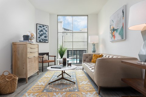 a living room with a couch and a table and a window