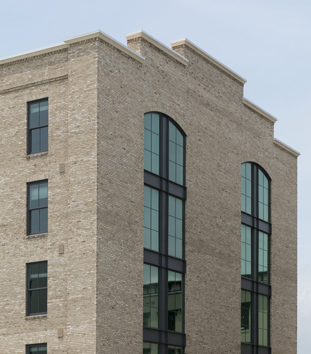 the exterior of a brick building with large windows