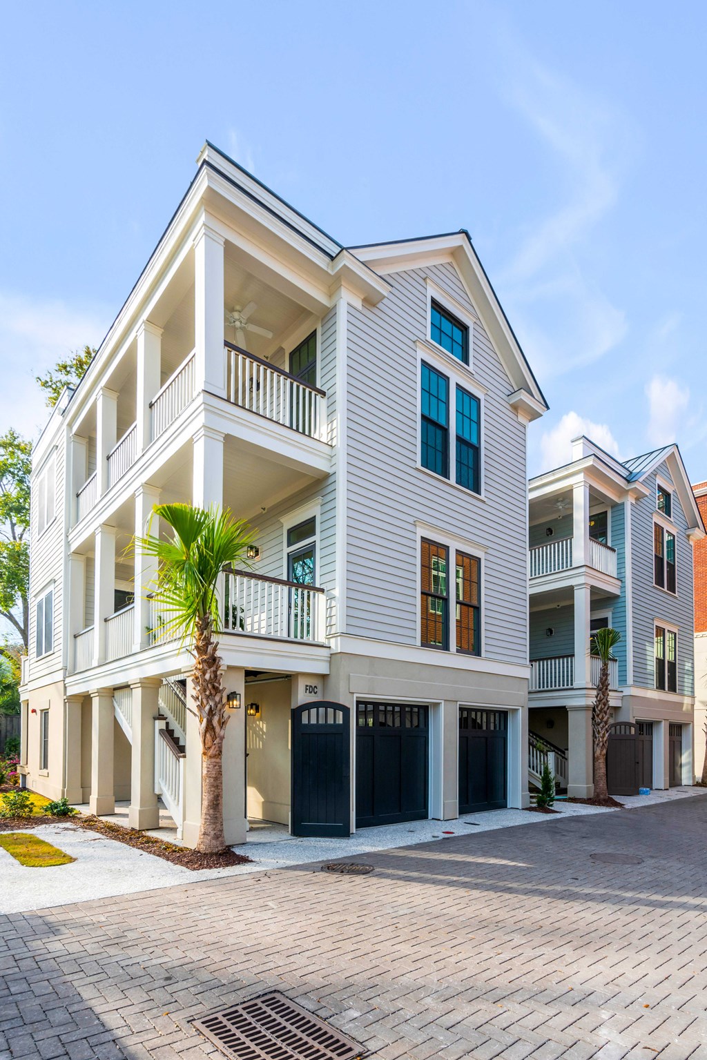 a white house with a palm tree in front of it