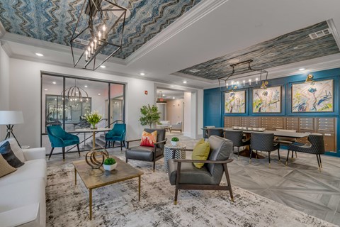 a living room with blue walls and chairs and a table with chairs