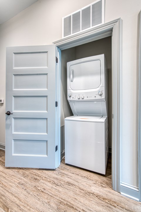 A white oven and dishwasher are in a cabinet.