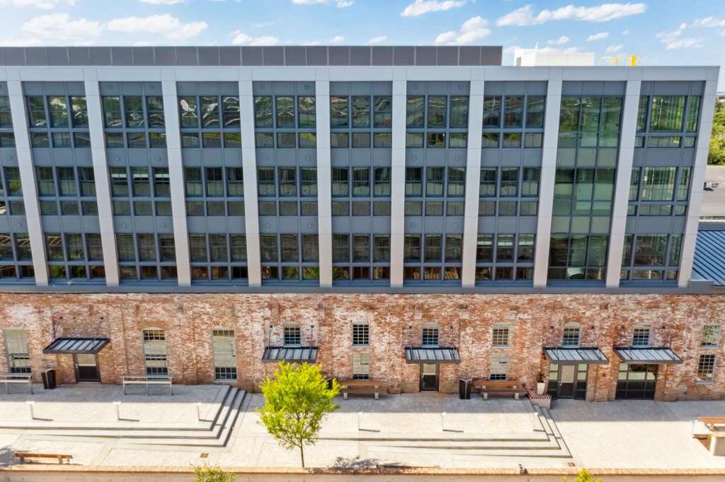 the facade of a building with benches in front of it