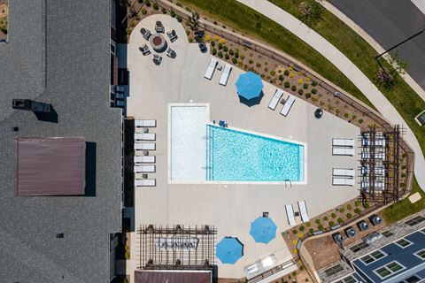 arial view of a swimming pool in the middle of a parking lot