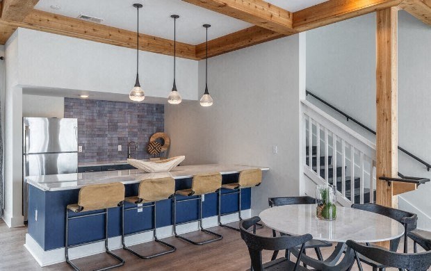 a kitchen with an island and a table with chairs