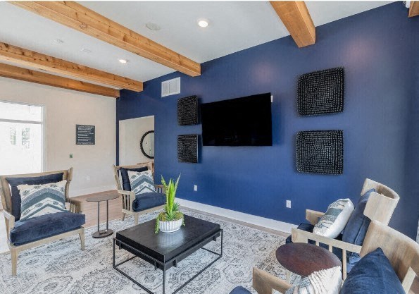 a living room with a blue wall and a tv
