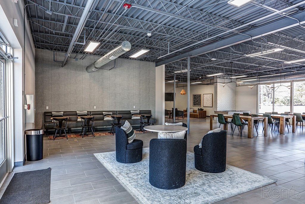 a large room with tables and chairs and a lobby