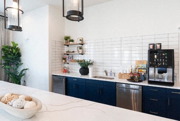 a white kitchen with blue cabinets and a counter top