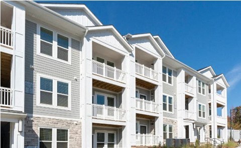 a row of white apartment buildings with balconies