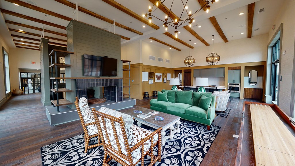 a large living room with a green couch and a table